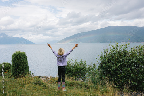 A girl on the hill with a fjord view in Norway photo