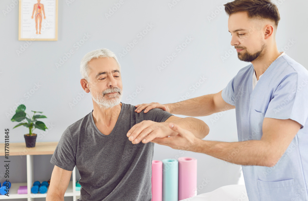 Physiotherapist helps old white haired pensioner male patient regain elbow mobility after stroke. Physiotherapy clinic, physio therapy, medical rehabilitation for senior patients concept Physiotherapist helps old white haired pensioner male patient regain elbow mobility after stroke. Physiotherapy clinic, physio therapy, medical rehabilitation for senior patients concept