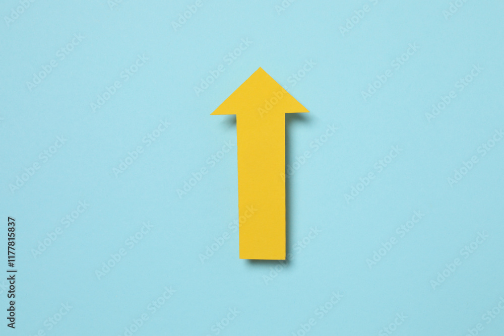 Paper arrow on color background, top view Paper arrow on color background, top view