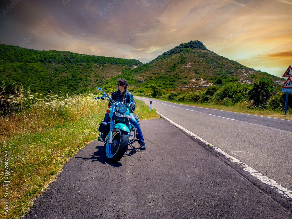 Biker sitting on his motorcycle on the side of the road Biker sitting on his motorcycle on the side of the road