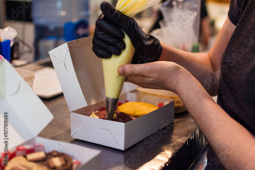 Worker finishing up cookie orders photo