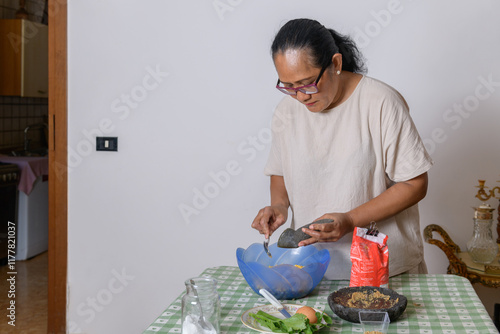 Woman making indonesian corn fritters Bakwan Jagung photo