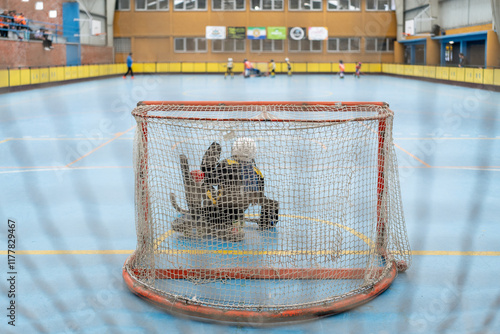 Roller hockey goalie protecting goal during championship game photo