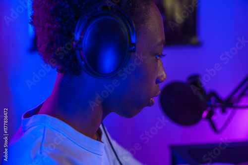 Young Gamer Wearing Headphones with Microphone photo