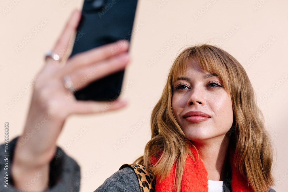 Closeup of young woman taking a selfie outdoors in cold spring Closeup of young woman taking a selfie outdoors in cold spring