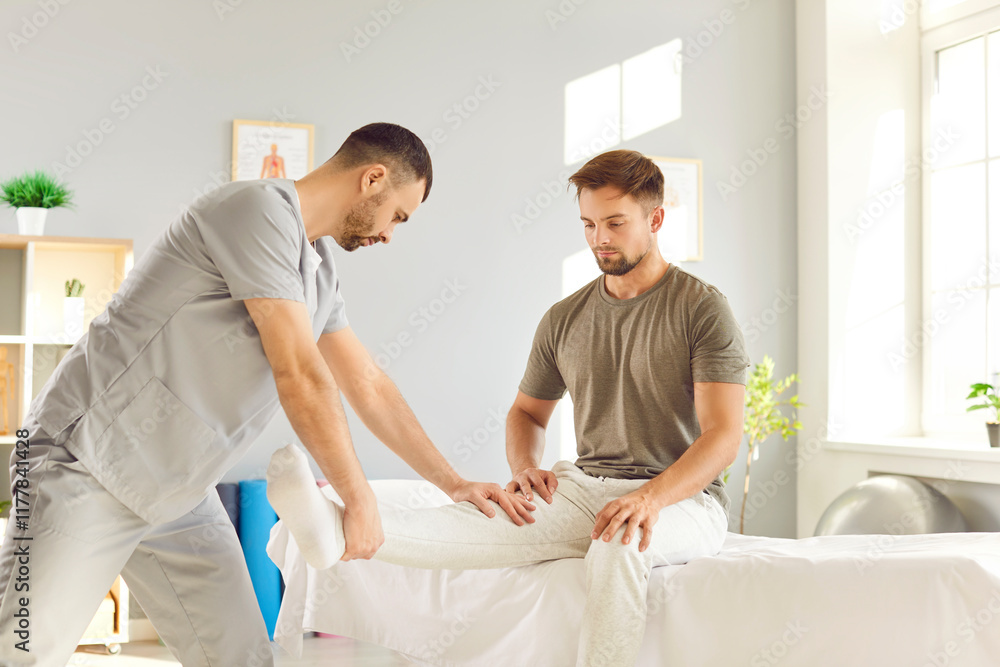 Fototapeta premium Rehabilitation and therapy professional trainer nurse, manual therapy chiropractor, physical therapist doctor doing massage to cure leg injury and trauma, traumatologist, physician orthopedic surgeon