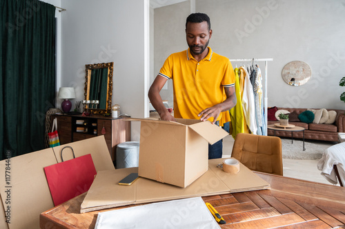 Man At Home Preparing Boxes For Delivery photo