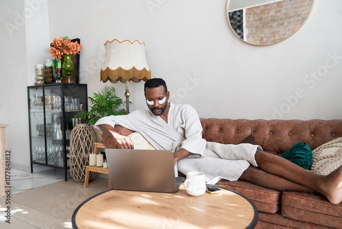 Man Working Remotely And Doing Skincare Routine At The Same Time photo