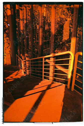 Captivating orange light filters through urban staircase design photo