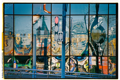 Reflections of urban life on modern glass building photo