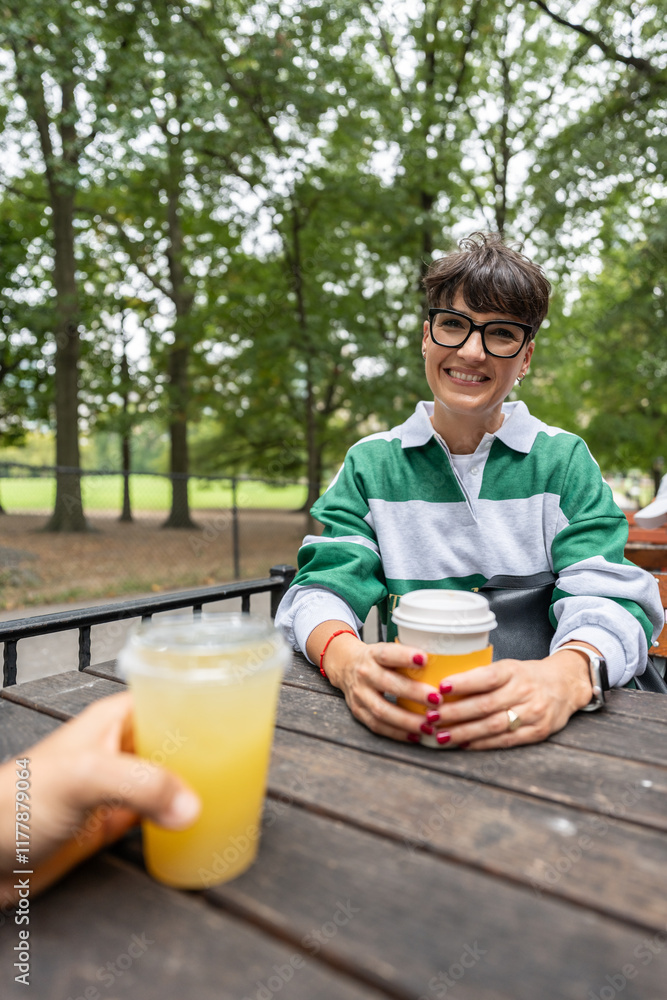 Woman drinking coffee and having a lemonade in manhattan park Woman drinking coffee and having a lemonade in manhattan park