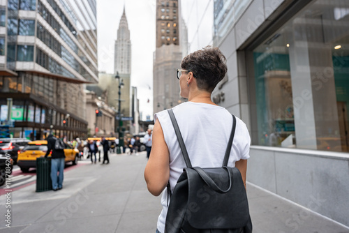 Tourist walking in manhattan admiring chrysler building, new york city