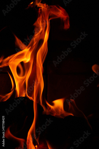 Burning wood in the fireplace in the house. Cozy atmosphere with a burning 