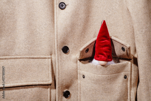 santa claus peeking out from the pocket of his jacket photo