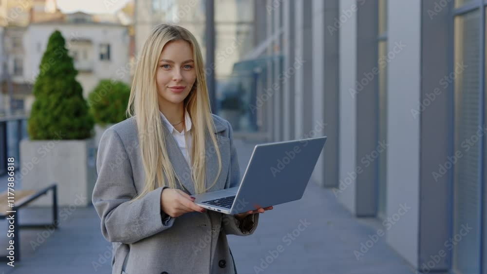 Portrait of the Lady Professional Expert Freelancer Proprietor Leader Woman Standing in Urban Area Close to Corporate Establishment Holding Laptop. Technology and People Concept Portrait of the Lady Professional Expert Freelancer Proprietor Leader Woman Standing in Urban Area Close to Corporate Establishment Holding Laptop. Technology and People Concept