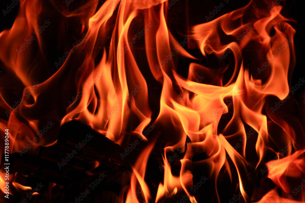 Burning wood in the fireplace in the house. Cozy atmosphere with a burning Burning wood in the fireplace in the house. Cozy atmosphere with a burning