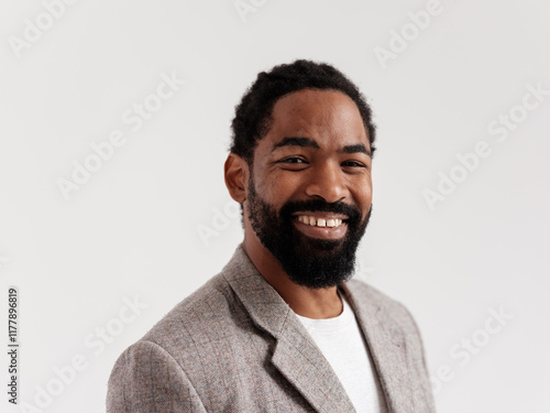 Smiling Man in Casual Blazer Against a Plain Background photo