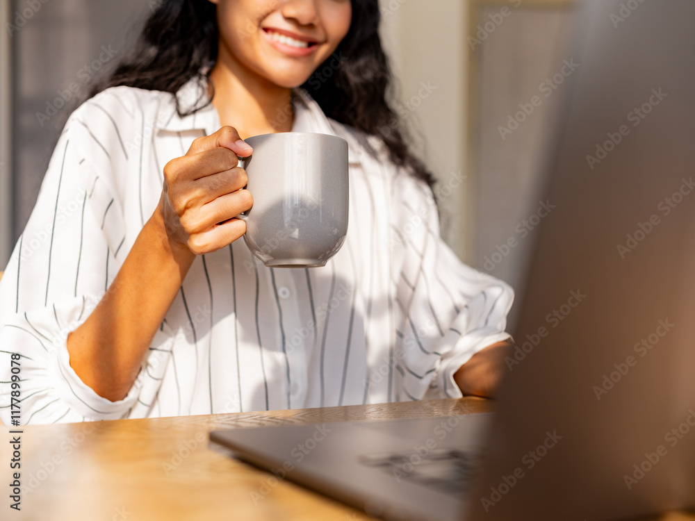 Woman Enjoying Coffee While Working on Laptop at Home Woman Enjoying Coffee While Working on Laptop at Home