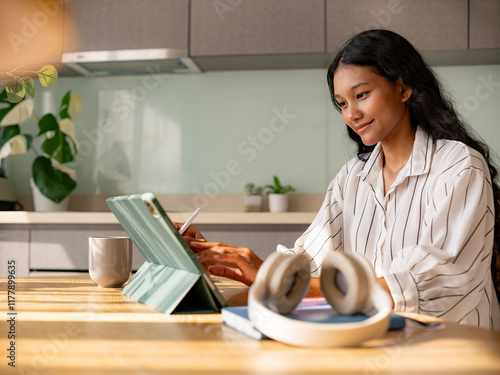 Young Woman Working Remotely With Digital Tablet At Home photo