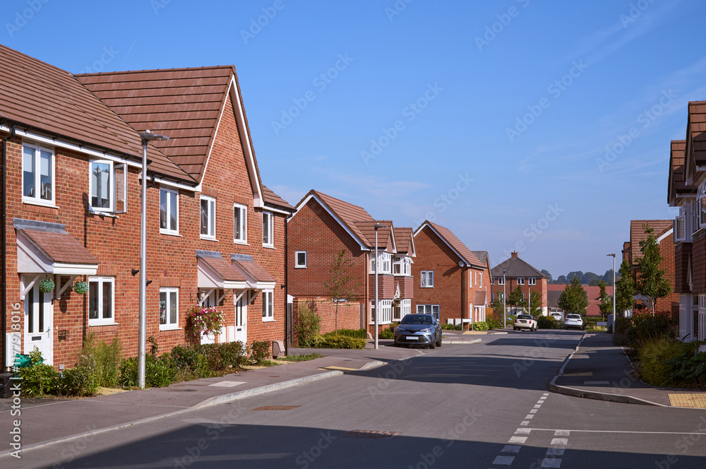 Quiet residential street lined with red brick homes on a sunny day Quiet residential street lined with red brick homes on a sunny day