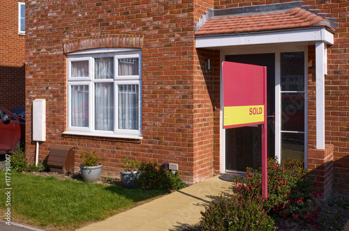 Sold family home in a quiet neighborhood on a sunny day photo