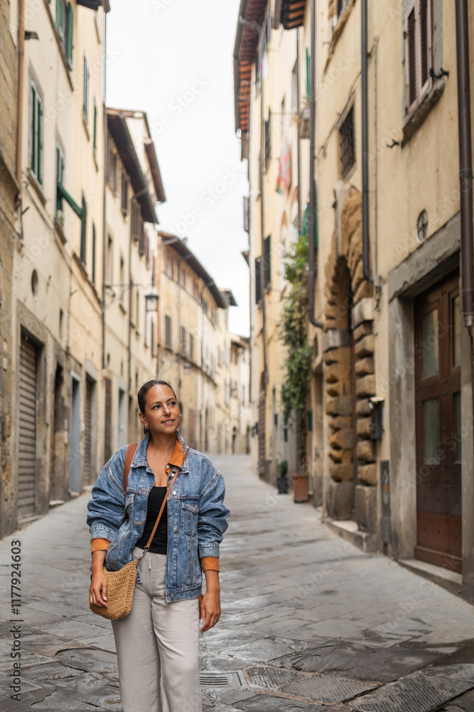Woman walking through the streets of the town of Arezzo in Tuscany Woman walking through the streets of the town of Arezzo in Tuscany