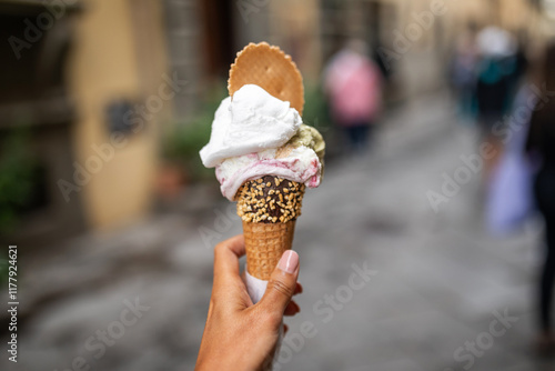 ugc of woman showing a large ice cream in a village in italy