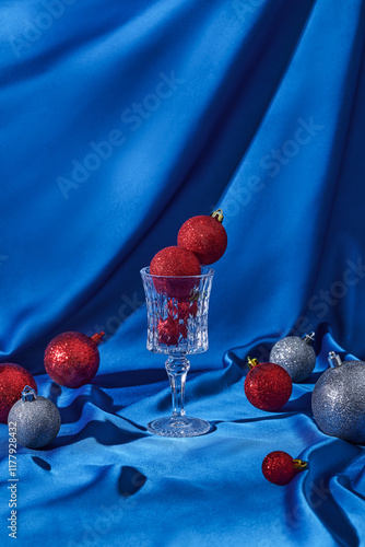 Festive Red and Silver Baubles on Blue Fabric Background photo