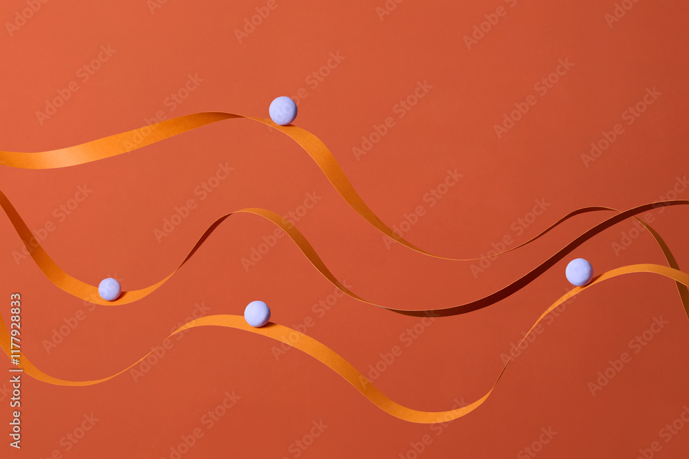© Marc Tran/Stocksy - Abstract Minimalist Art With Orange Ribbons and Blue Spheres