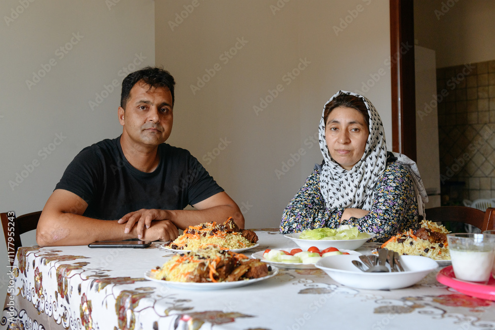 Afghan family at the table with national dishes Afghan family at the table with national dishes
