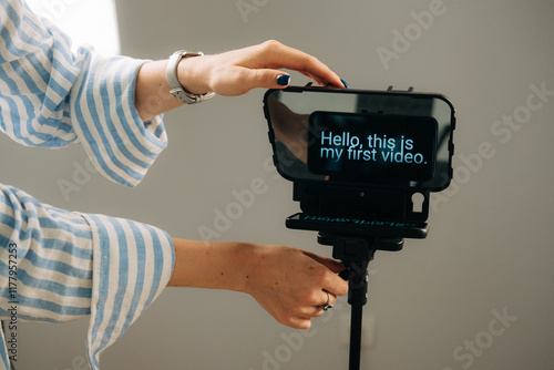 Anonymous woman adjusting teleprompter for video recording sessi