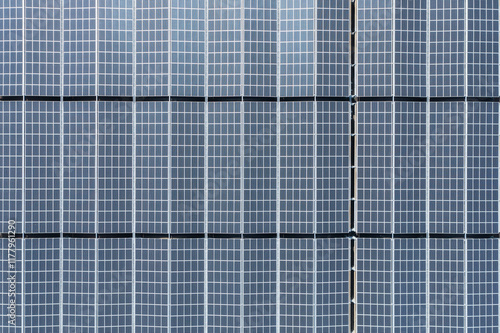 Aerial view of solar power panel on rooftop arranged in neat row photo