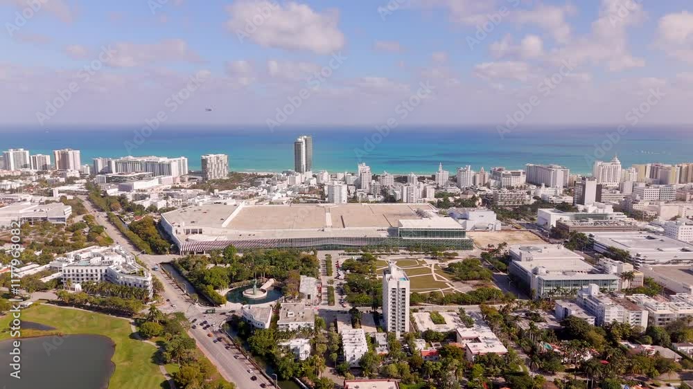 Miami Beach Convention Center 2025. Aerial view of city buildings and clean blue ocean horizon Miami Beach Convention Center 2025. Aerial view of city buildings and clean blue ocean horizon