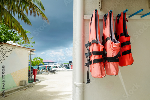 Bright Orange Life Jackets Hanging in Maafushi photo