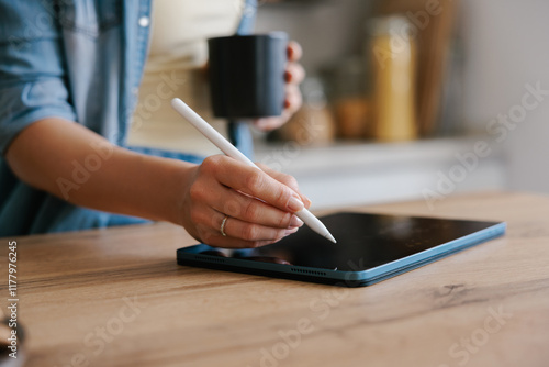 Woman Using Digital Pen on Tablet  photo