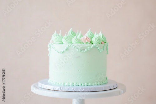 vintage-style single-tiered cake in mint green with elegant piped designs, ribbon accents, and a classic, timeless charm photo