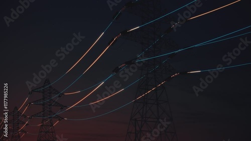 Glowing power lines and transmission towers in the dark. Loopable Ultra HD 4K animation