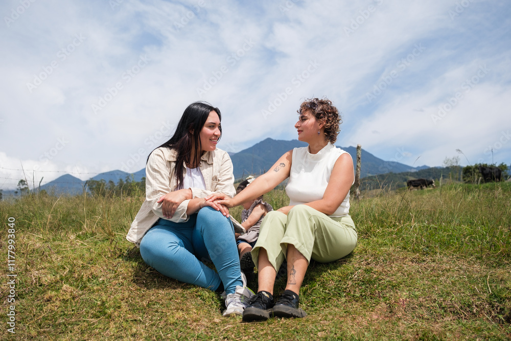 Lesbian mothers sharing a tender moment with their daughter in nature Lesbian mothers sharing a tender moment with their daughter in nature