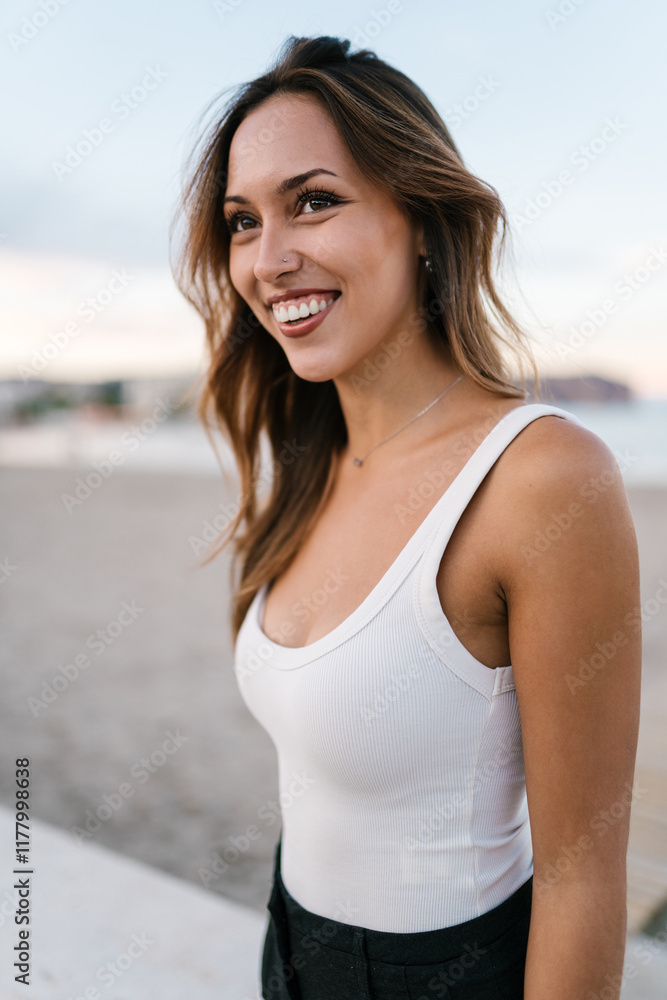 Woman smiling and enjoying a day at the beach Woman smiling and enjoying a day at the beach