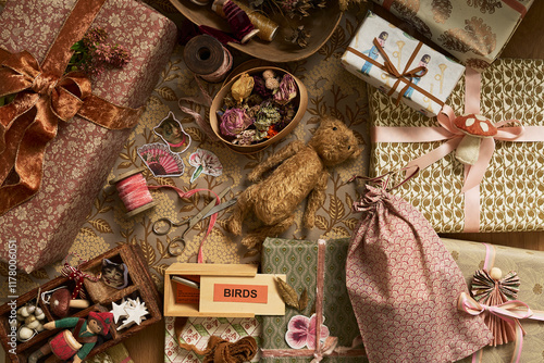 Wrapping Christmas gifts with vintage paper, ribbons and bows photo