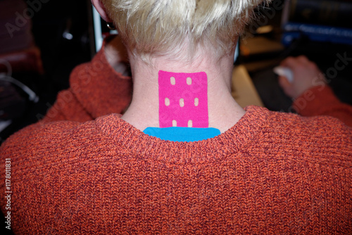 A young man wearing colourful kinesiology tapes  photo