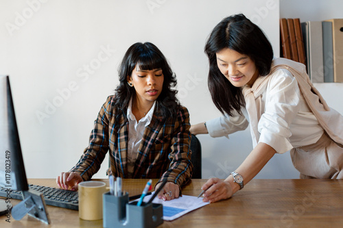 Office manager supervising documents in office