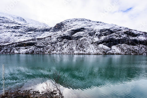 A winter landscape along the Sognefjellsvegen road in Norway, featuring snow-covered mountains and a vast, serene terrain. photo