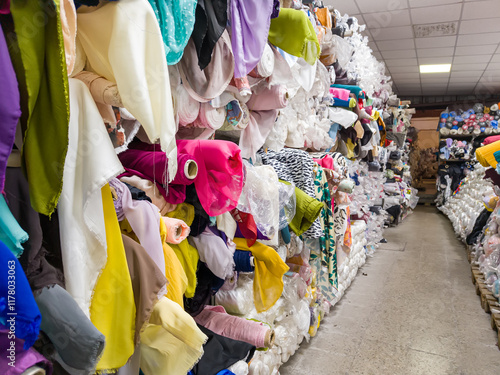 Colorful Rolls of Fabric in a Textile Warehouse. Fabric and cloth store with sewing and crafting materials and fashion supplies.