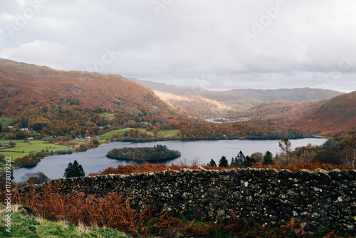 Lake Grasmere with cloudy skies and a traditional stone wall photo