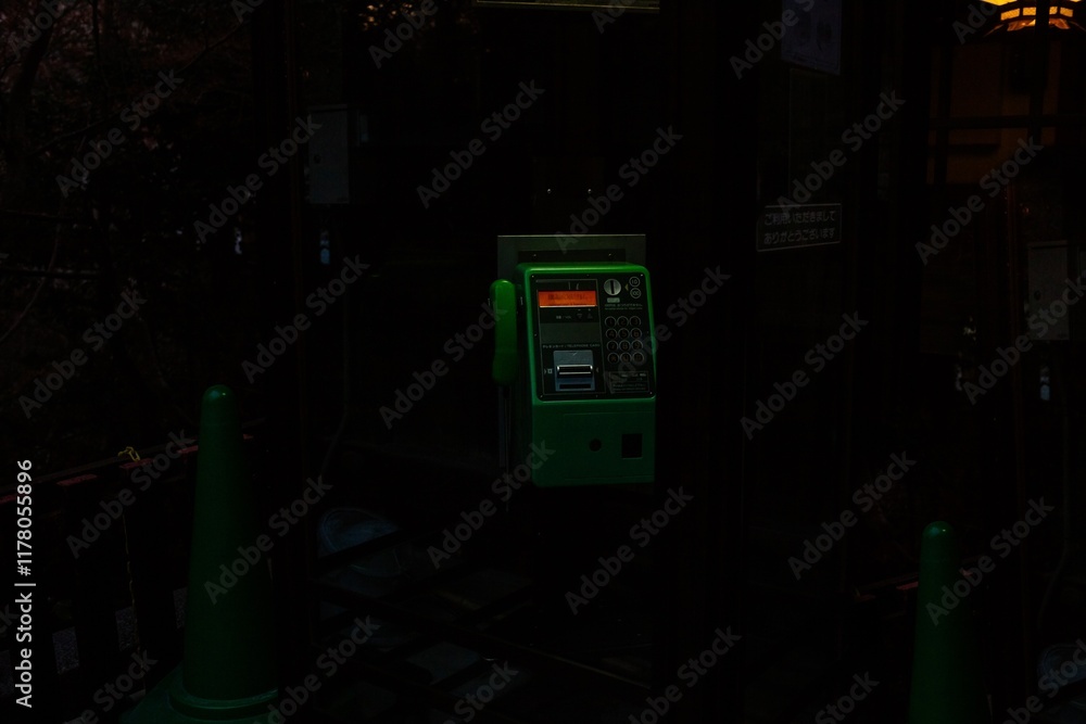 Green phone booth in a temple at night in Japan. Green phone booth in a temple at night in Japan.