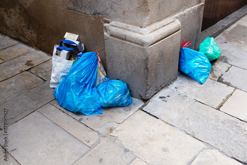 Bright blue plastic bags in a corner of concrete wall urban city 