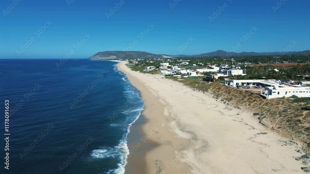 Aerial View of Ocean Waves, Rocky Mountains, and Sandy Beach with Greenery Aerial View of Ocean Waves, Rocky Mountains, and Sandy Beach with Greenery