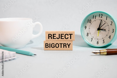 Text Prevent Bigotry written in blue under a wire mesh. photo