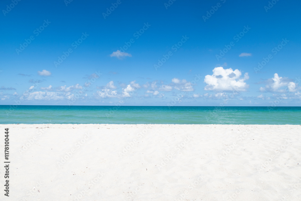 Miami beach turquoise water ocean, white sand and blue sky Miami beach turquoise water ocean, white sand and blue sky